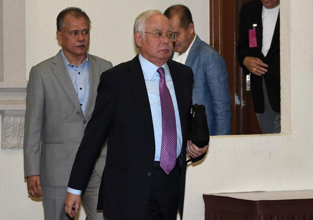 Former Prime Minister Datuk Seri Najib Abdul Razak leaves the courtroom during a stoppage in his trial on the misappropriation of SRC International Sdn Bhd funds at the Kuala Lumpur Court Complex on June 18, 2019. - Bernama