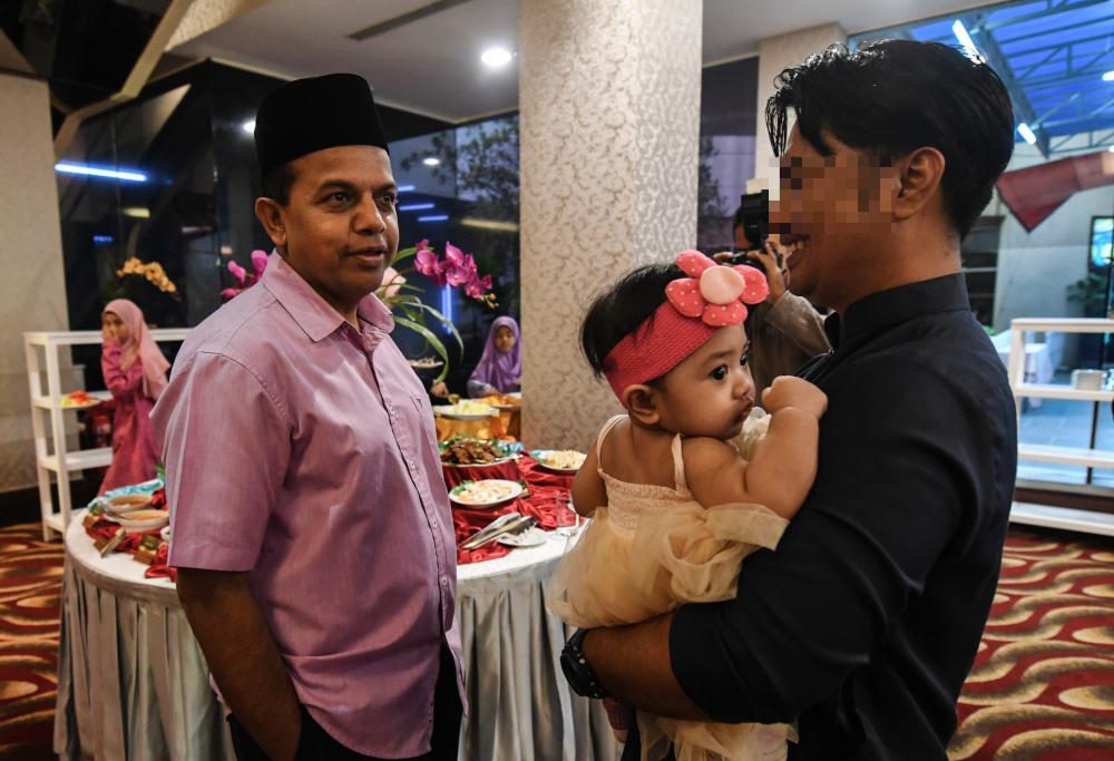 Bukit Aman Special Branch Counter Terrorism director Datuk Ayob Khan Mydin Pitchay (L) welcomes a former militant detainee at the Ramadan break-of-fast organised by the Bukit Aman Special Branch E8 Division, last night. - Bernama
