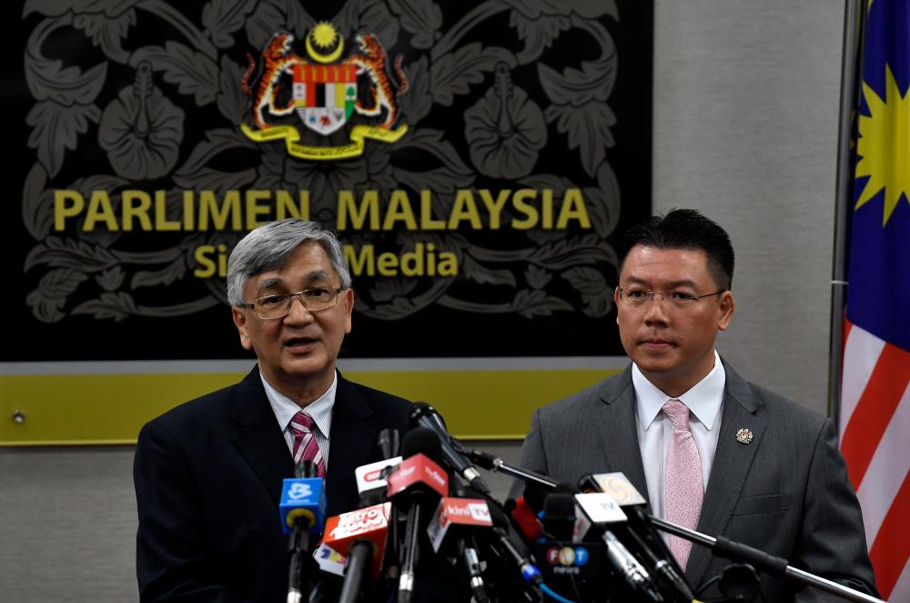 Former Dewan Rakyat Speaker Tan Sri Mohamad Ariff Md Yusof (L) and former Deputy Dewan Rakyat Speaker speak to the media at a press conference in Parliament today. - Bernama