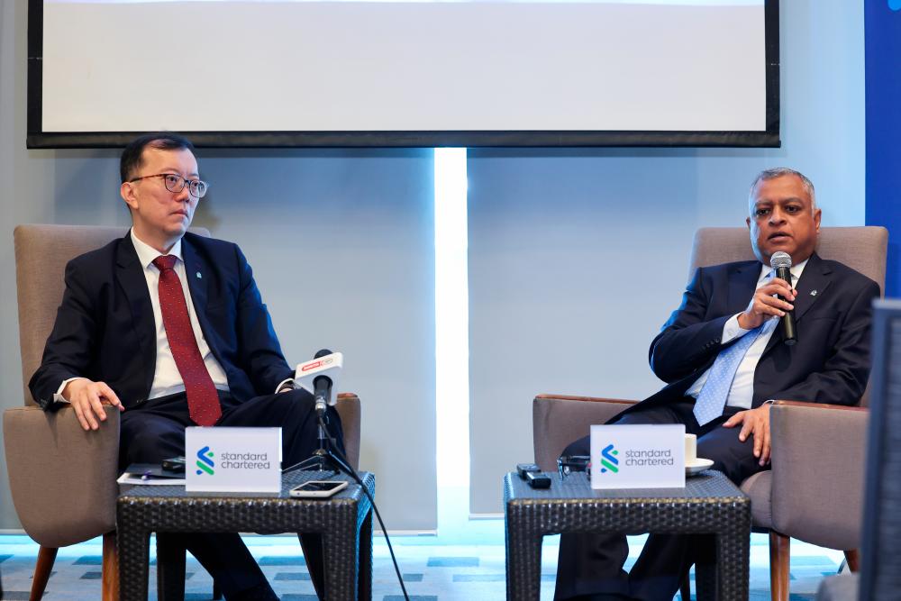 Lee (left) and Kaushik at a press conference in conjunction with Standard Chartered’s Global Focus-Economic Outlook 2024 on a Soft Landing, With Risk today. – Bernamapic