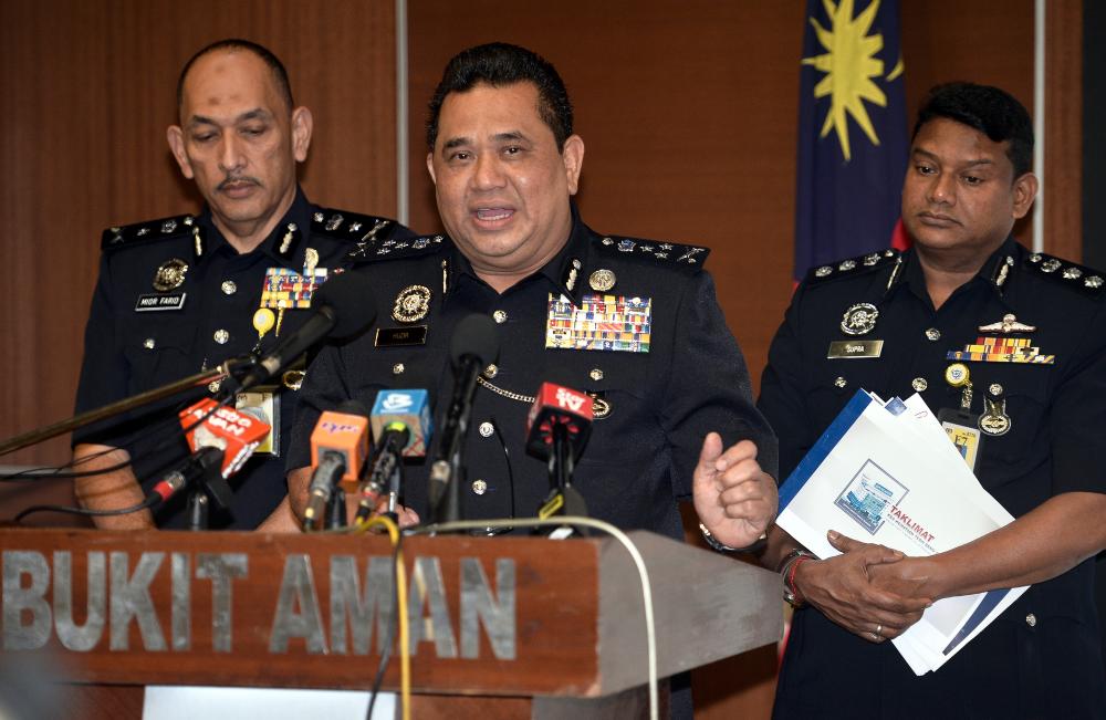 Federal police CID director Commissioner Datuk Huzir Mohamed (C) speaks during a press conference at Bukit Aman today. - Bernama