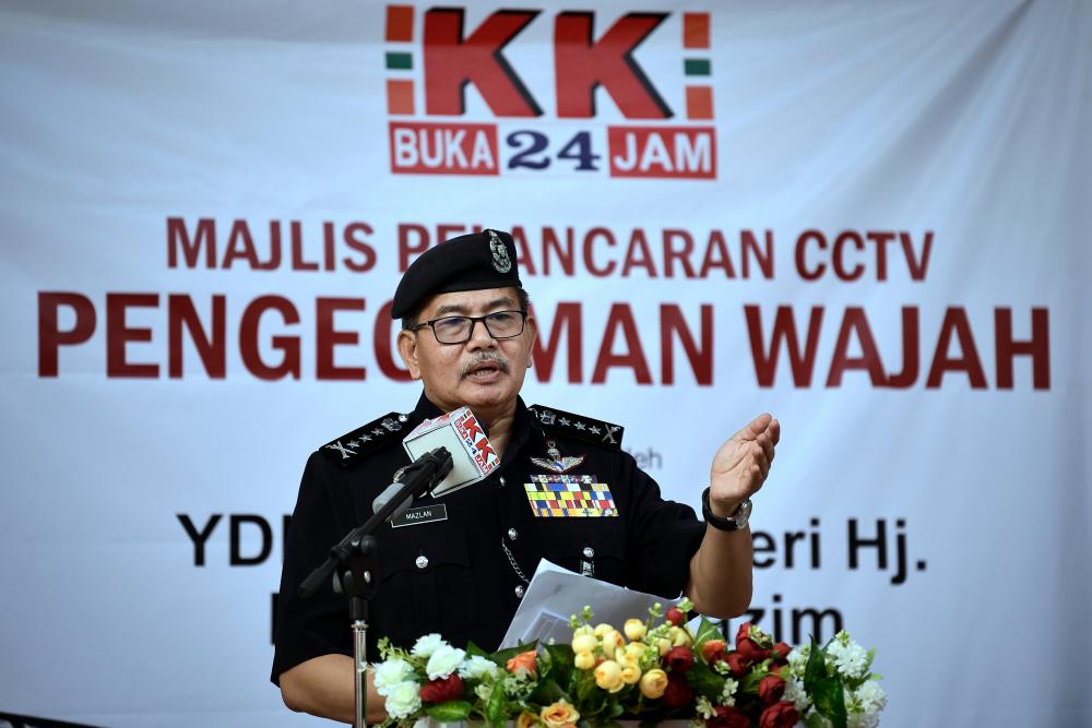 Kuala Lumpur Police chief Datuk Seri Mazlan Lazim talks at the launch of the facial recognition CCTV system at KK Mart, Taman Desa Petaling yesterday. — Bernama