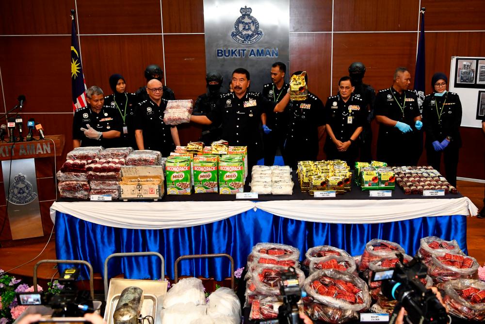 Bukit Aman NCID director Datuk Ramli Din displays the quantities of drugs seized during Op Nutcracker, which crippled two drug distribution syndicates in Sarawak at a special press conference in Bukit Aman today. - Bernama
