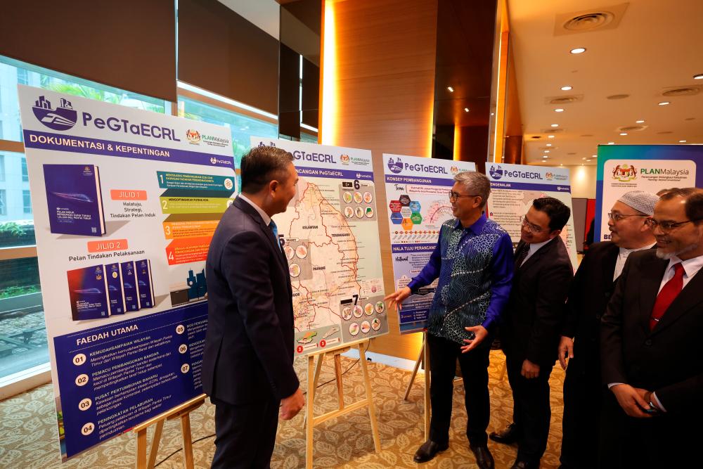 Investment, Trade and Industry Minister Tengku Datuk Seri Tengku Zafrul Abdul Aziz (two from left) during a Seminar on East Coast Rail Link- Economic Accelerator Project (ECRL-EAP) Business and Investment Opportunities at MIDA Sentral today. - BERNAMApix