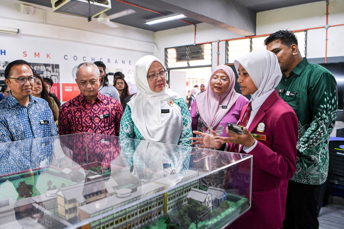 Minister in the Prime Minister’s Department (Federal Territories), Datuk Seri Dr Zaliha Mustafa (third from left), listening to an explanation by SMK Cochrane Resource Centre prefect, Nur Arisyah Abdul Rahman (right), during a brief visit after officiating the Federal Territories-level Leadership, Climate Change and Green Energy Programme (IKLIM) 2025 at SMK Cochrane, Kuala Lumpur, today. – BERNAMA