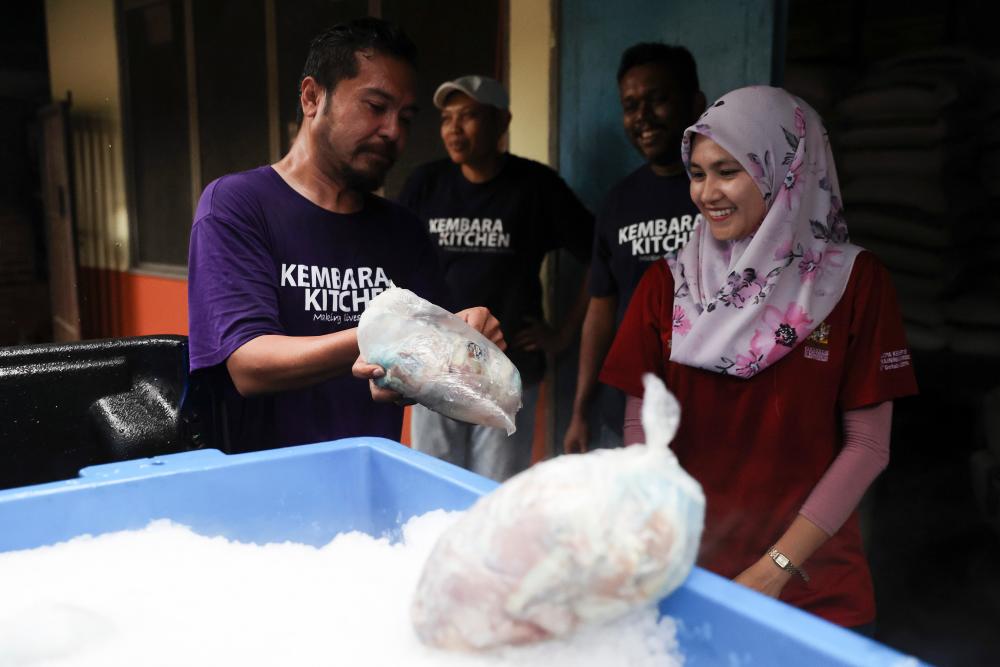 Volunteers from Kembara Kitchen present officers from Zoo Negara with donation in the form of animals’ food, on March 4, 2020. — Bernama