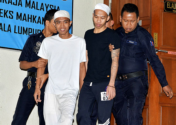Filepix taken on Mac 29, 2017 shows Imam Wahyudin Karjono, 21, (left) and Jonius Ondie @ Jahali, 25, (two, right), appearing at the Kuala Lumpur High Court in relation to their bombing of the Movida nightclub in Puchong. — Bernama
