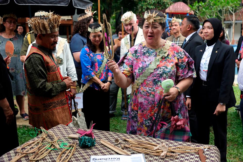 The governor-general of New Zealand Dame Cindy Kiro and spouse Dr Richard Davies looking at indigenous community craft on display during their visit to Alang Manja Resort, Gombak with indigenous community organized by JSGM today/BERNAMAPix