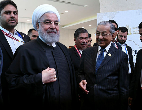 Prime Minister and KL Summit 2019 Chairman Tun Dr Mahathir Mohamad greeting Iranian President Hassan Rouhani (second, left) upon arrival for the opening of Kuala Lumpur Summit 2019 at the Kuala Lumpur Convention Centre yesterday.