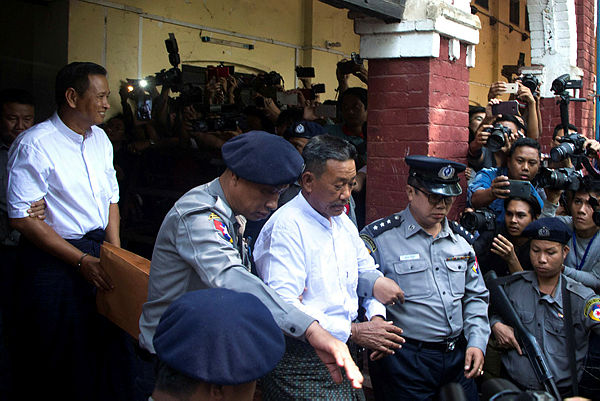 Kyi Lin, (C), the gun man who shot and killed Ko Ni, a legal advisor to Aung San Suu Kyi’s National League for Democracy, followed by accomplice Aung Win Zaw, (L), are escorted by police after a court verdict in Yangon — AFP