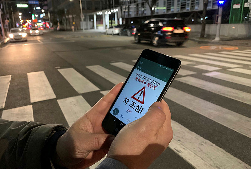 Kim Jong-hoon, a senior researcher at Korea Institute of Civil Engineering and Building Technology (KICT) demonstrates an application ‘Watch Out’ that gives an alert to a user distracted by using smart phone while crossing a zebra crossing, in Ilsan, South Korea, March 12, 2019. — Reuters