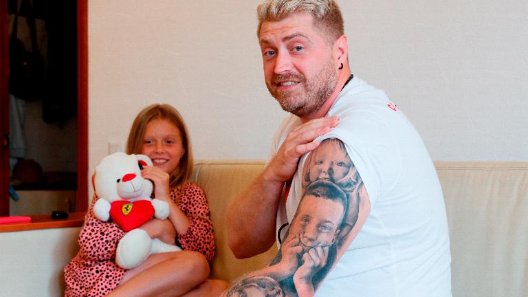 Konstantin Yakovlev, a 36-year-old Belarusian handball coach, shows the tattoos of his children on his arm in Kyiv, Ukraine. – REUTERSPIX