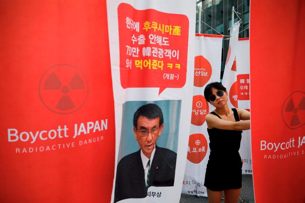 A South Korean woman attends an anti-Japan rally near the Japanese embassy in Seoul, South Korea, August 3, 2019. REUTERS/Kim Hong-Ji