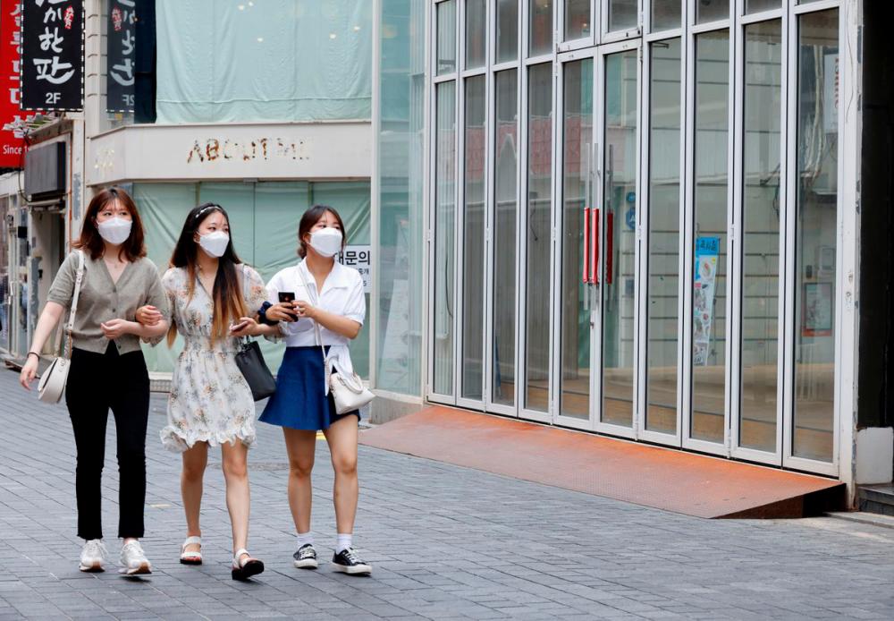 Women wearing masks walk in a shopping district amid the coronavirus disease (Covid-19) pandemic in Seoul, South Korea, July 9, 2021. -Reuters