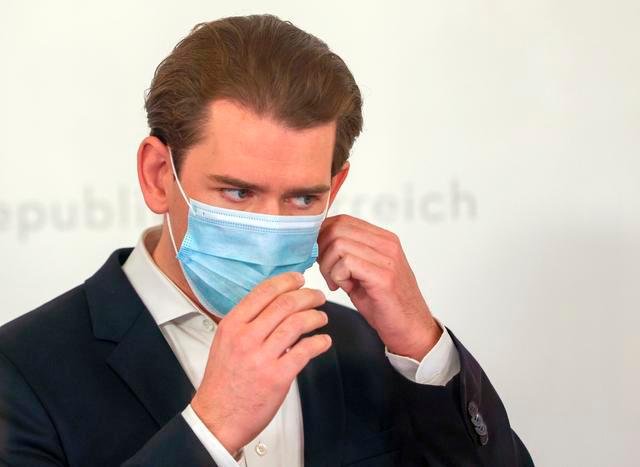 Austria’s Chancellor Sebastian Kurz takes of his mask as he arrives to a news conference, as the spread of the coronavirus disease (Covid-19) continues, in Vienna, Austria November 25, 2020. — Reuters