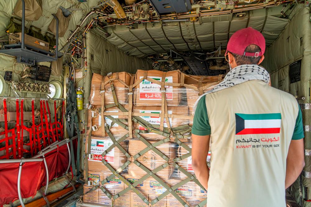 A handout photo released by the Kuwaiti news agency KUNA shows humanitarian aid, bound for Gaza through Egypt, being loaded into a military aircraft at the International Airport in Kuwait City on October 26, 2023. AFPPIX