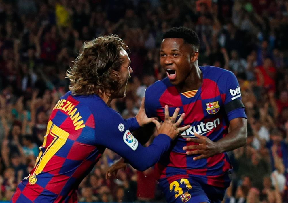 Barcelona's Anssumane Fati celebrates scoring his first goal with Antoine Griezmann, during the FC Barcelona v Valencia game at Camp Nou, Barcelona, Spain on September 14, 2019. - Reuters