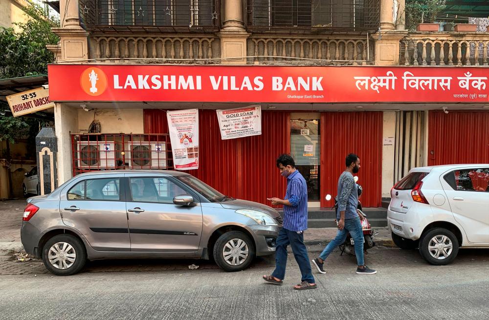 People walking past a Lakshmi Vilas Bank branch in Mumbai, India, on Wednesday. – REUTERSPIX