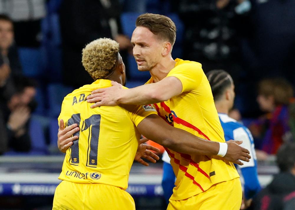 Soccer Football - LaLiga - Espanyol v FC Barcelona - RCDE Stadium, Barcelona, Spain - February 13, 2022 FC Barcelona's Luuk de Jong celebrates scoring their second goal with teammate Adama Traore/REUTERSPix