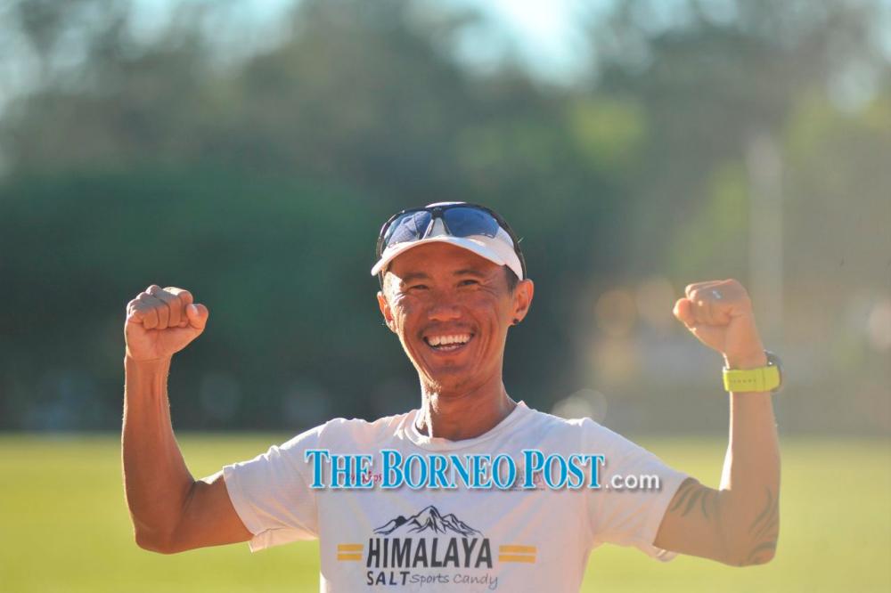 An all-smiling Ong posing for the camera after completing his 1,600km run. — The Borneo Post