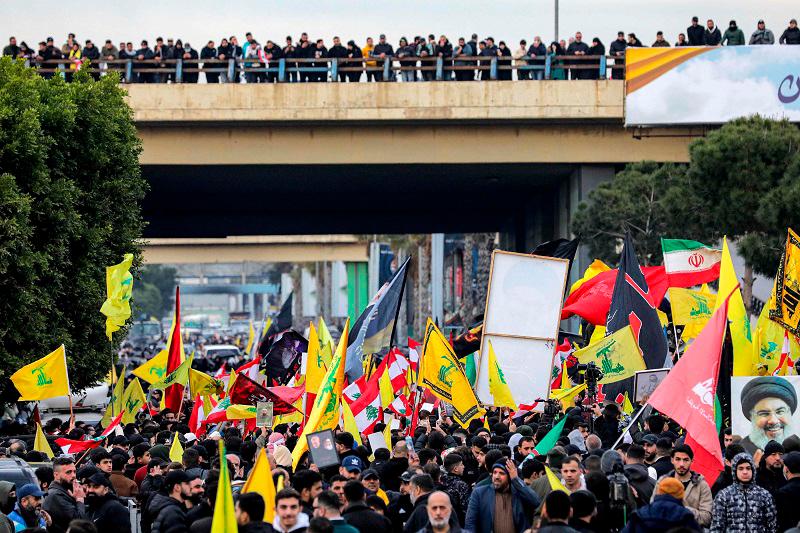 Supporters of the Lebanese Shiite Islamist movement Hezbollah gather for a rally to block the road to Beirut International Airport over a decision to bar two Iranian flights from landing there, in Beirut on February 15, 2025. An AFP correspondent said tear gas was fired to disperse crowds on February 15 after again blocking amidst calls by the Iran-backed group for a sit-in. - Ibrahim AMRO / AFP