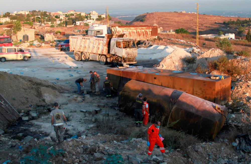 Lebanese army soldiers and rescuers are seen at the site of a fuel tanker explosion in Akkar, in northern Lebanon, August 15, 2021. — Reuters