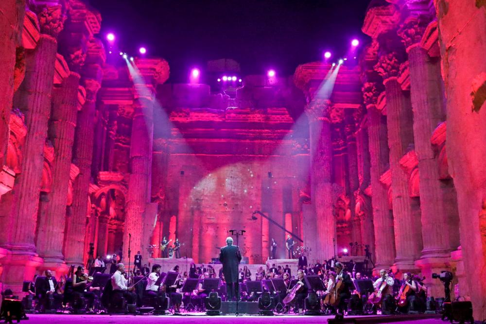 Maestro Harout Fazlian conducts rehearsals ahead of the Sound of Resilience concert inside the Temple of Bacchus at the historic site of Baalbek in Lebanon’s eastern Bekaa Valley, on July 4, 2020. / AFP / -