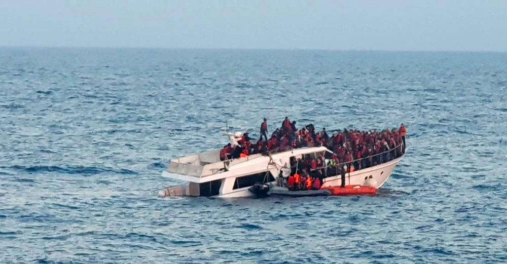 A handout photo provided by the Lebanese Army on December 31, 2022, shows a sinking migrant boat in Mediterranean waters, off the country’s northern coast near Tripoli during a rescue operation by the Lebanese navy/AFPPix