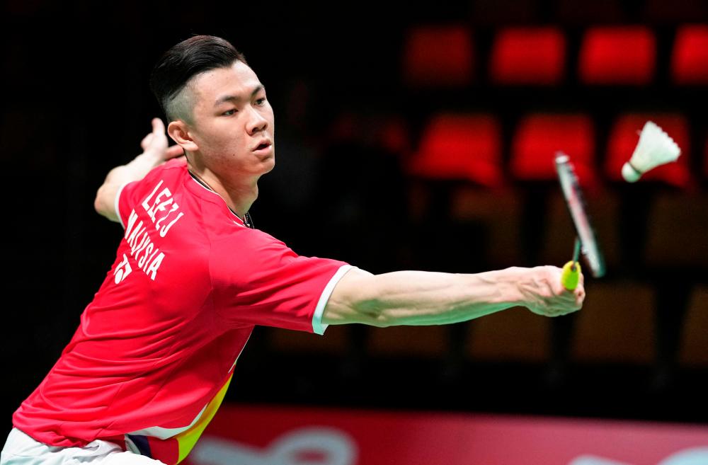 Malaysia's Jia Lee Zii competes with Japan's Kento Momota (unseen) during a men's single match in the Thomas Cup men's team Badminton match between Japan and Malaysia in in Aarhus, Denmark, on October 14, 2021. AFPpix