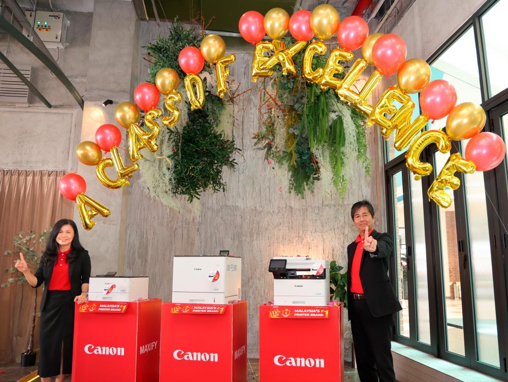 (From left) Lee and Yoshiie unveiling Canon’s next generation of laser printers. - PICS COURTESY OF CANON