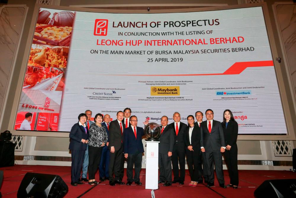 Leong Hup executive chairman Lau Chia Nguang (front row, fourth from left) and executive director Tan Sri Lau Tuang Nguang (front row, fifth from left) launching the group’s IPO prospectus at The St. Regis Kuala Lumpur.