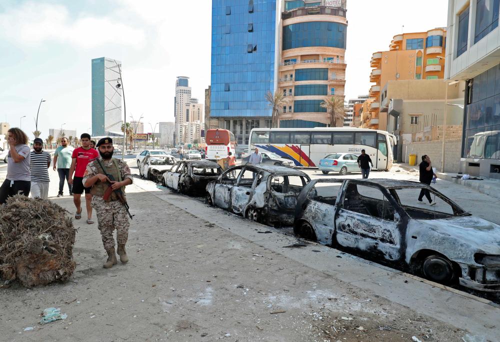 This picture taken on on May 17, 2022 in Libya's capital Tripoli shows a view of vehicles destroyed during fighting between forces loyal to the Tripoli-based Prime Minister Abdulhamid Dbeibah and rival forces of the Tobruk-based government, after the latter forces withdrew. AFPpix