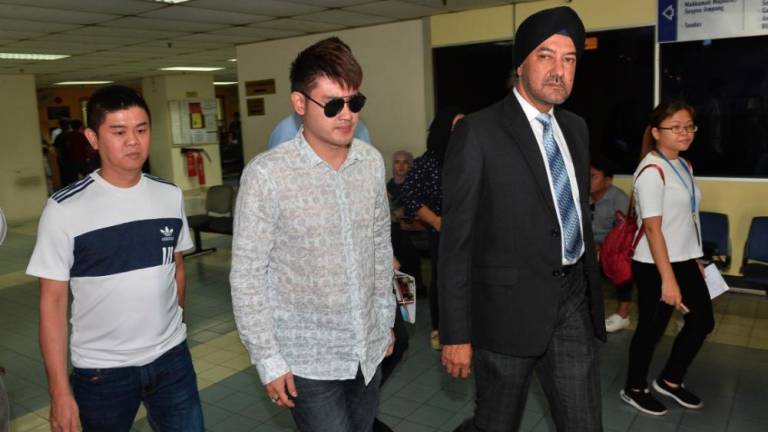 Businessman Datuk Seri Liow Soon Hee (L2) and his defence lawyer, Datuk Seri Rajpal Singh leave the courtroom at the Ampang magistrate’s court on May 10, 2019. - Sunpix