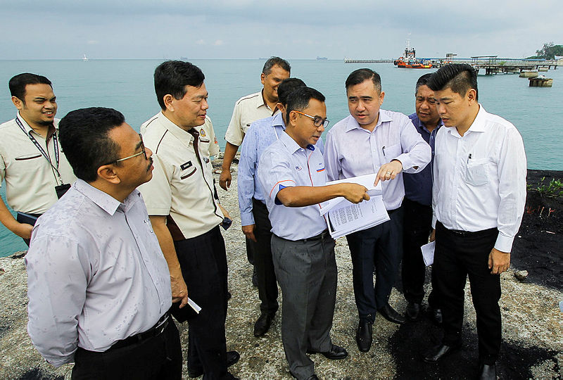 Transport Minister Anthony Loke Siew Fook (3rd R) listens to a briefing by the Railway Assets Corporation (RAC) manager Datuk Baharin Datuk Abdul Hamid (4th R), on May 24, 2019. — Bernama