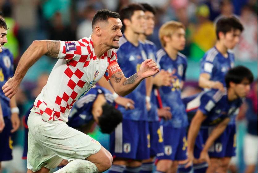 Football - FIFA World Cup Qatar 2022 - Round of 16 - Japan v Croatia - Al Janoub Stadium, Al Wakrah, Qatar - December 5, 2022 Croatia’s Dejan Lovren celebrate qualifying for the quarter finals as Japan players look dejected after being eliminated from the World Cup REUTERSPIX