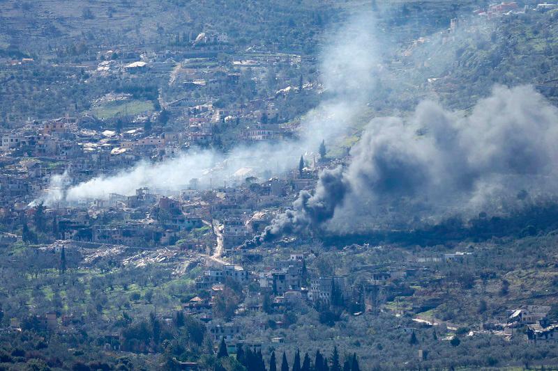 A photo taken from the southern Lebanese area of Marjayoun, shows smoke rising from buildings in the southern Lebanese village of Kfar Kila during an Israeli army operation in the village on February 15, 2025. (Photo by Rabih DAHER / AFP)