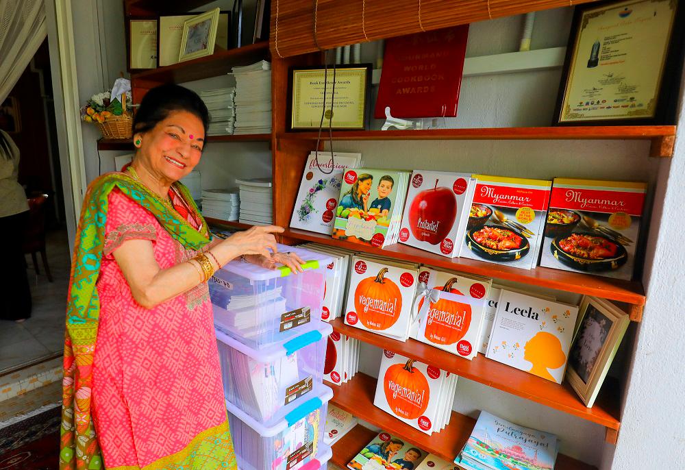 Mohana strikes a proud pose with her collection of books. $!Mohana strikes a proud pose with her collection of books.