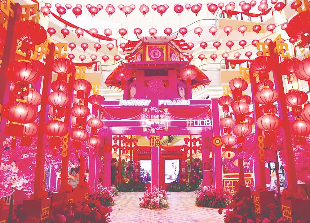 Sunway Pyramid’s decorations combine oriental structures, vibrant blossoms and glowing lanterns.