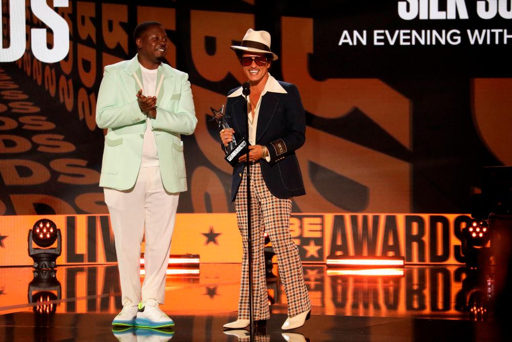 Silk Sonic accept the Album of the Year award at the BET Awards 2022. – Reuters