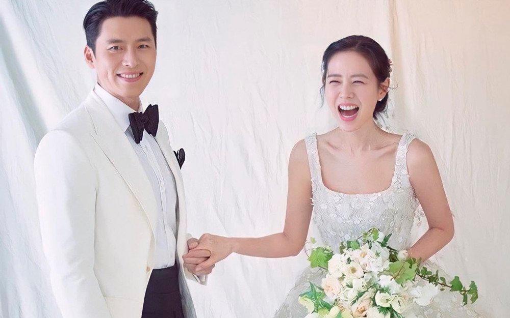 The happy couple during their March wedding. – AllKpop