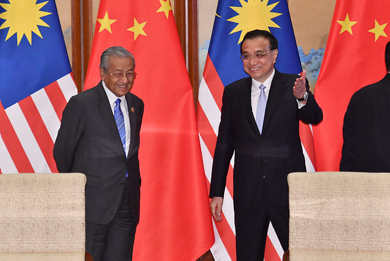 China’s Premier Li Keqiang (R) gestures to Prime Minister Tun Dr Mahathir Mohamad (L) during a signing ceremony between the two countries at the Diaoyutai State Guesthouse in Beijing on April 25, 2019. — AFP