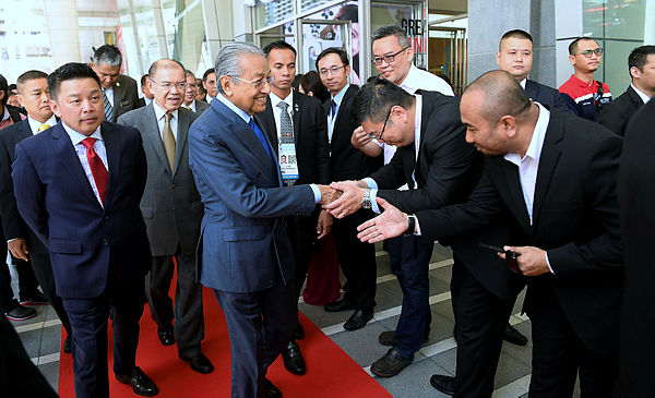 Prime Minister Tun Dr Mahathir Mohamad shakes hands while visiting the Launch of Malaysia Fest 2019 that showcases the best of Malaysia through food, products and cultural performances on June 21 in Bangkok, Thailand. — Bernama