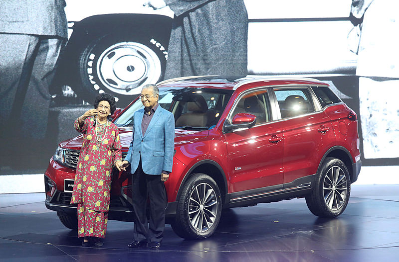 Prime Minister Tun Dr Mahathir Mohamad and Tun Dr. Siti Hasmah pose for a photograph with the brand new Proton X70. — Sunpix by Asyraf Rasid