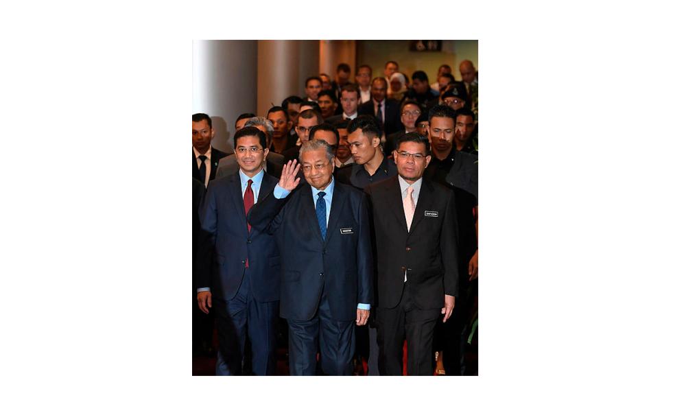 Prime Minister Tun Dr Mahathir Mohamad, with Datuk Seri Azmin Ali (to his left) and Datuk Seri Saifuddin Nasution Ismail (to his right), arrive to attend the 20th Asia Oil and Gas Conference 2019 opening ceremony, on June 24, 2019. — Bernama