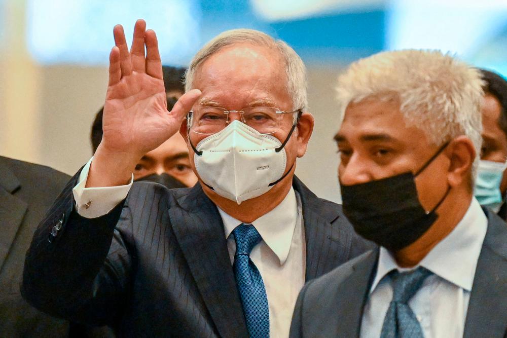 Malaysia’s former prime minister Najib Razak waves as he arrives at the federal court in Putrajaya on August 15, 2022. Malaysia’s highest court on August 15 will hear former leader Najib Razak’s final bid to overturn his 12-year jail sentence for corruption, with an acquittal potentially clearing the way for his return to power. AFPPIX