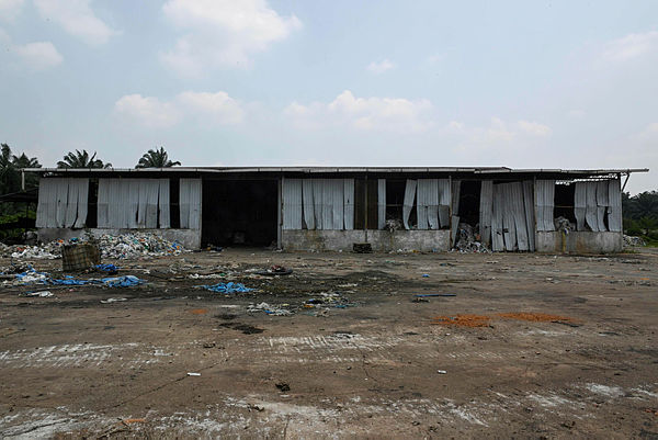 This picture taken on March 8, 2019 shows an abandoned factory with plastic waste in Jenjarom, Kuala Langat. — AFP