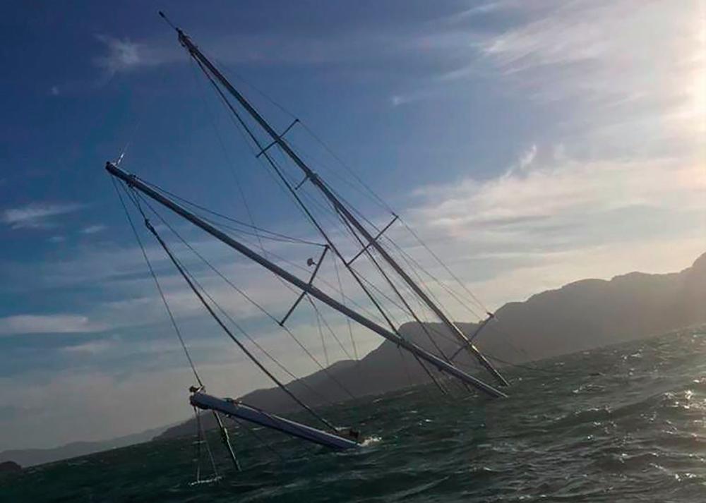 This handout photo taken on February 19, 2021 and released by the Malaysian Maritime Enforcement Agency on February 21 shows the multi-million-dollar sailing yacht “Phocea” sinking after a fire off the resort island of Langkawi. AFP PHOTO / MALAYSIAN MARITIME ENFORCEMENT AGENCY