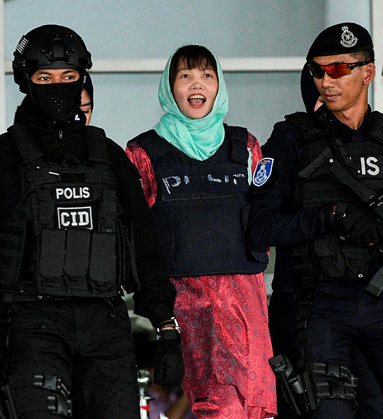 Vietnamese national Doan Thi Huong (C) is escorted by police out of the High Court in Shah Alam on April 1, 2019. — AFP
