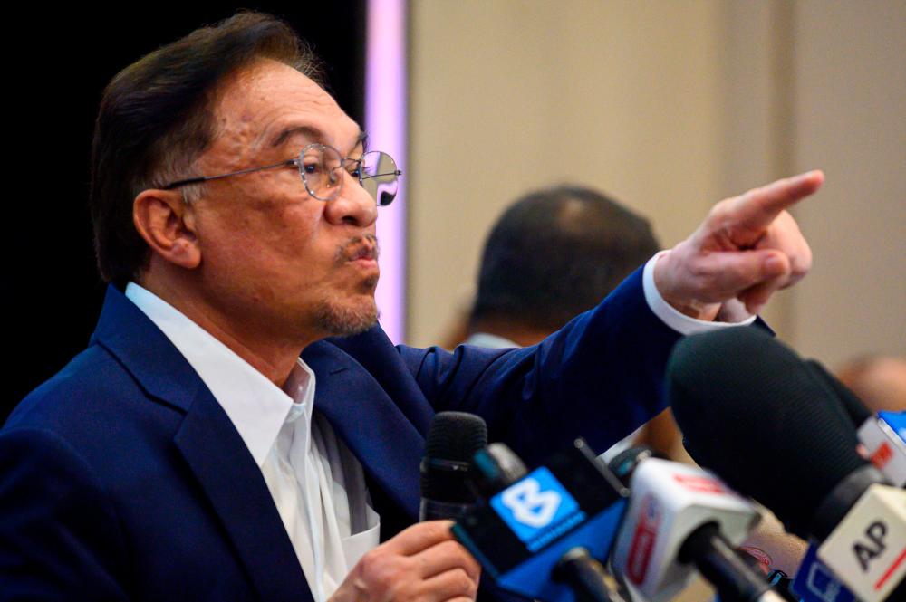 Malaysian opposition leader Anwar Ibrahim points during a press conference at a hotel in Kuala Lumpur on September 23, 2020. — AFP