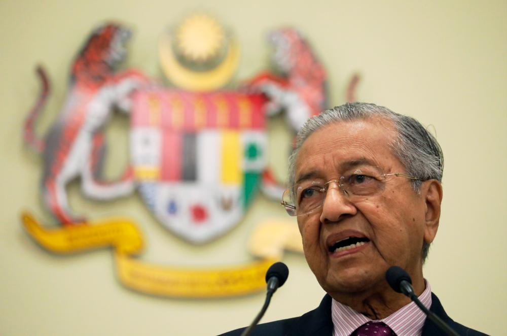 Interim Prime Minister Tun Dr Mahathir Mohamad speaks during a news conference in Putrajaya, today. - Reuters